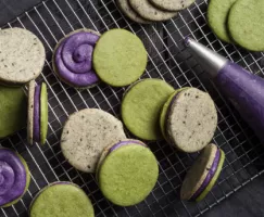 Halloween Sandwich Cookies with Ube Frosting on a wire cooling rack