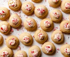 Peppermint thumbprint cookies decorated with crushed candy canes
