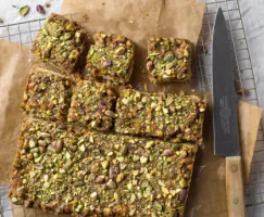 Pistachio Caramel Shortbread Bars on brown butcher paper